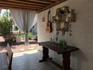 a room with a table and a guitar on the wall at Vila Elna in 2 Mai