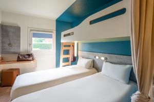Postel nebo postele na pokoji v ubytování Ibis budget Rouen Petit Quevilly + 33 fotografií