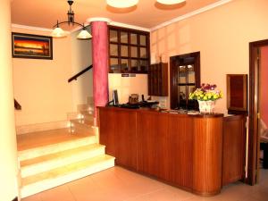 a lobby with a counter with flowers on it at Hotel Rural en Escalante Las Solanas in Escalante