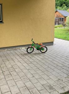 a small green motorcycle parked next to a building at Frühstückspension Josefinum in Bad Aussee