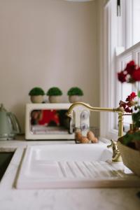 a kitchen sink with a faucet in a kitchen at Keenaghan Cottage Belleek in Belleek