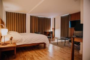 a bedroom with a bed and a desk and a piano at Hope Street Hotel in Liverpool
