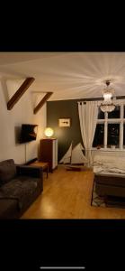 a living room with a bed and a couch at Stensö Room in Kalmar