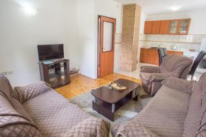 a living room with couches and a coffee table at Apartments Dedeic in Žabljak