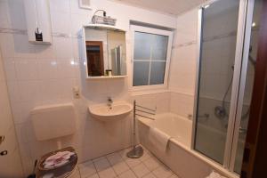 a bathroom with a sink and a toilet and a shower at Apartment Moselblick in Ürzig +18 photos