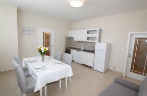 a dining room with a table and chairs and a kitchen at Rezidence U prince č.3 in Jičín +7 photos