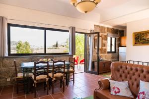 a living room with a table and chairs and a couch at Charming House in Fornos with shared pool in Fornos