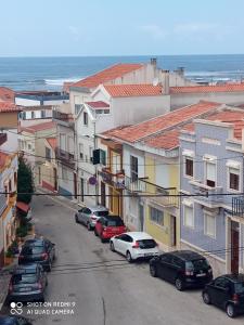 a city street with cars parked in front of buildings at CASA do BATORÉU - BUARCOS 120 MT PRAIA in Figueira da Foz