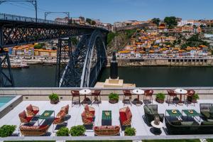 a view of a bridge with chairs and a table at Vincci Ponte de Ferro in Vila Nova de Gaia