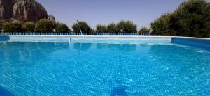 a large swimming pool with blue water at Baglio Del Sole in San Vito lo Capo +81 photos