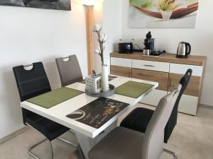 una sala da pranzo con tavolo e sedie di Penthouse - Sunset Dream a Uhldingen-Mühlhofen