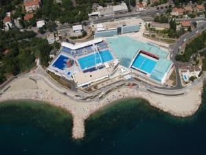 an aerial view of a building with two swimming pools at APARTMAN BORGO MARINA - by the sea in Rijeka