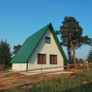 a white and green barn with a green roof at Zabljak_vikendica in Žabljak