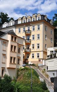 a large yellow building with a staircase in front of it at Festival in Karlovy Vary