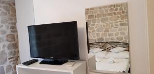 a flat screen tv sitting on a dresser with a mirror at Antea in Split