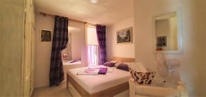 a small room with a bed and a chair at beach house in Starigrad
