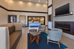 a lobby with a couch and chairs and a fireplace at Holiday Inn Express Chillicothe East, an IHG Hotel in Chillicothe