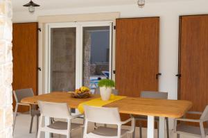 a dining room with a wooden table and chairs at Villa Zala in Rasopasno