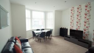 a living room with a table and chairs and a couch at ELSK Apartments by Sasco in Blackpool