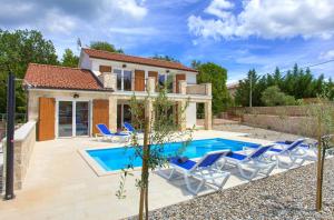 a villa with a swimming pool and a house at Villa Zala in Rasopasno