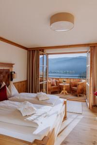 a bedroom with a large bed and a large window at Landhaus Leopoldhof in St. Wolfgang