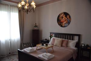 a bedroom with a bed and a clock on the wall at B&B Le rose di Paola in Santa Maria a Monte