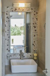 a bathroom with a sink and a mirror at Sunshine in Naxos Chora