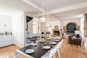 a dining room and living room with a table and chairs at La Villa Souhaitier in Saint Malo
