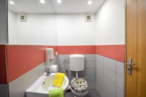 a bathroom with a toilet and a sink at Unirii Suites in Bucharest