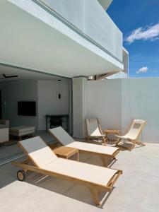 a group of chairs and tables in a room at Vila Villaarh in Krk