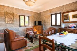 a living room with a table and chairs at Idyllic Villa in Fornos + Pool! in Fornos