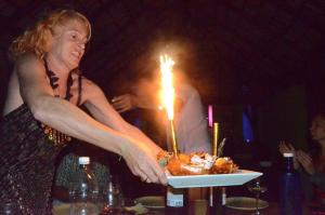 a woman holding a plate of food with a sparkler at Villa La Plantacion in Las Galeras +40 photos