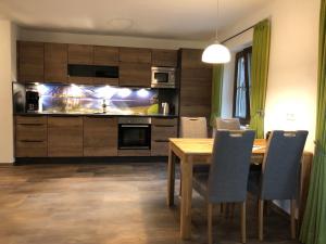 a kitchen with a wooden table and a dining room at Haus Christ in Anger