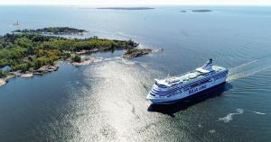 a cruise ship in the water next to an island at Tallink Silja Line Ferry - Helsinki to Stockholm in Helsinki