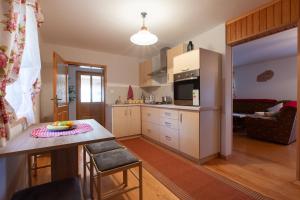 a kitchen with a table and a counter top at Kuća za odmor KRISTINA in Jasenak