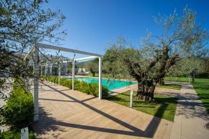 a swimming pool with a canopy next to a tree at iConic Wellness Resort & Spa in Arezzo +30 photos