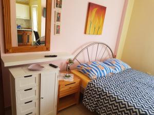 a bedroom with a bed and a dresser and a mirror at Hana in Umag
