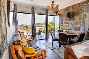 a living room with a couch and a table at Idyllic Villa in Fornos + Pool! in Fornos