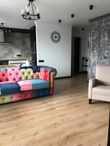 un soggiorno con un divano colorato e una sedia di 1 Мая ,8А a Čornomors'k