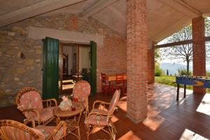 a living room with chairs and a table and a brick wall at Casale Tigli in Capolona