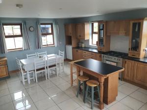 a kitchen with a table and chairs and a table and a tableablish at Murphys Irish Farmhouse in Tralee