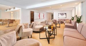 a waiting room with couches and chairs and a table at Hotel Zorna Plava Laguna in Poreč
