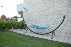 a hammock sitting next to a stone wall at Panorama Siviris in Siviri