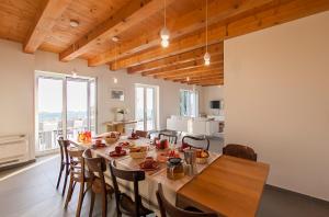 a dining room with a long table and chairs at Villa Ella in Vojnovo Selo