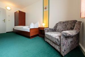 Un pat sau paturi într-o cameră la Hotel Asterra