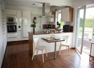 a kitchen with a table and chairs in a room at Ferienhaus Pusteblume in Freyung