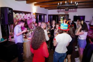 a group of people dancing at a birthday party at Casa Vatra Sinteului - Cu sala de evenimente de capacitate mare - Se inchiriaza integral in Socet