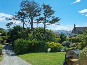 a garden with trees and bushes in a yard at Bridge View House B&B and Restaurant in Kilcrohane