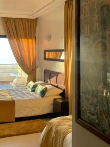 a hotel room with two beds and a window at Auberge Oualidia Dream in Oualidia