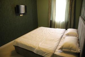 Postel nebo postele na pokoji v ubytování Hotel Gold